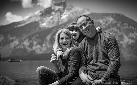 black and white family portrait laughing in front of teton mountains by Richard Horst Photography