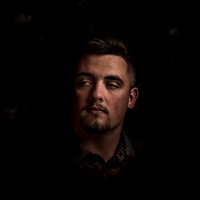 moody fine art portrait of man in dark lighting by Richard Horst Photography