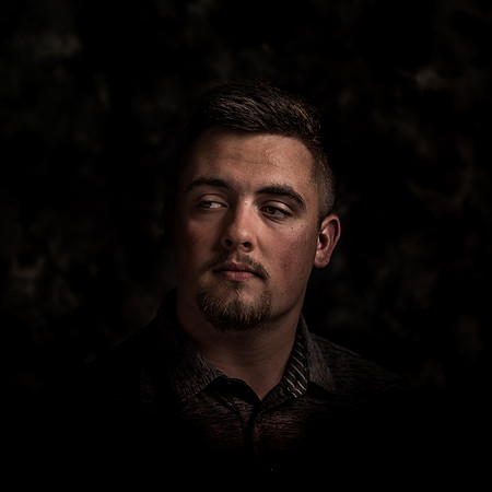 moody fine art portrait of man in dark lighting by Richard Horst Photography