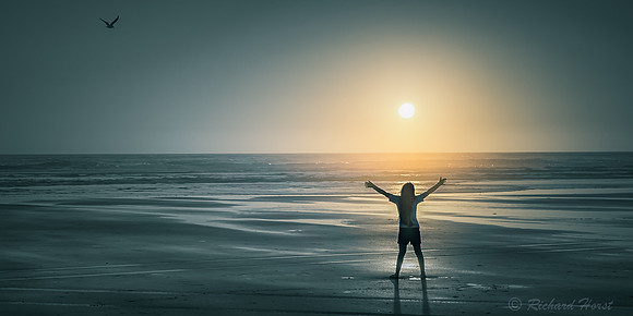 silhouette at sunset over pacific ocean arms open fine art seascape by Richard Horst Photography