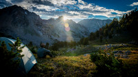 camper sitting beside tent at sunrise in mountain valley fine art landscape photograph by Richard Horst