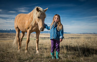 cowgirl with hat embracing horse in barn fine art western photograph by Richard Horst