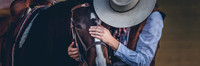 fine art western portrait of cowboy gently holding horse showing trust and connection by Richard Horst Photography